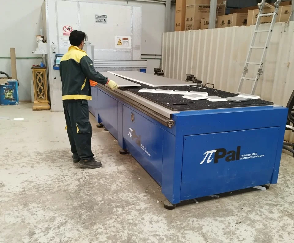 Kingspan PalDuct CNC line at the Mecamac factory in Al Misfah, Muscat — pre-insulated panels being cut
